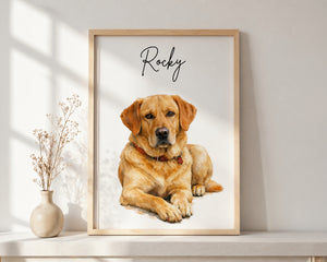 A framed custom pet portrait featuring a golden retriever dog named 'Rocky' in black script, displayed on a white shelf next to a small vase with dried stems.