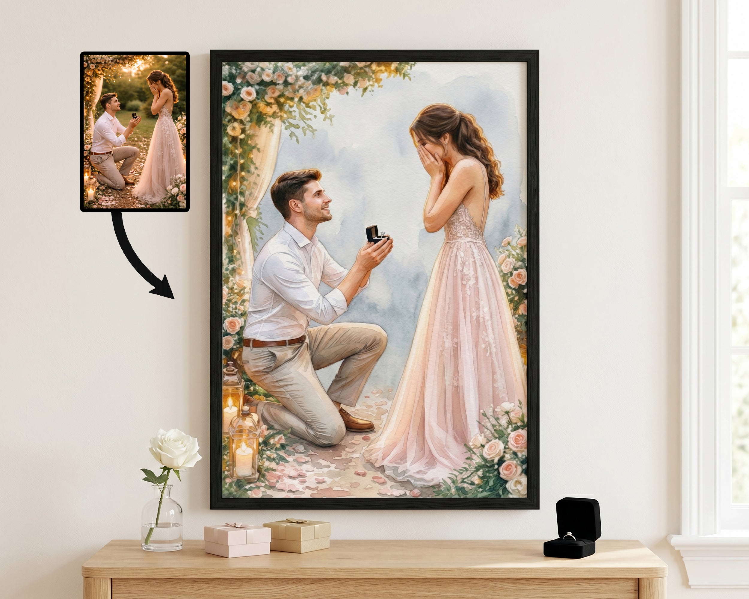 A framed art print displayed on a wall above a wooden console table. The print shows a romantic scene of a man kneeling to propose a ring to a woman in a pink gown, framed by floral arches.