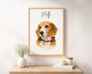 A framed custom pet portrait print featuring a watercolor-style beagle dog with the name 'Molly' written in black script at the top, displayed on a light wall above a wooden console table with a vase and candles.