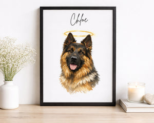 A framed custom pet portrait print featuring a German Shepherd dog with a gold halo and the name 'Chloe' in script, displayed on a wooden shelf next to a vase of baby's breath and a candle.