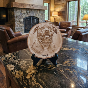 Wooden plaque with a dog's face engraving on a marble countertop in a cozy living room.