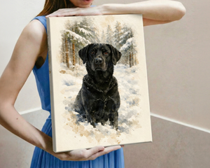 A woman in a blue dress holds up a custom watercolor canvas painting of a black dog sitting in a snowy forest. The canvas is shown against a neutral beige wall background.