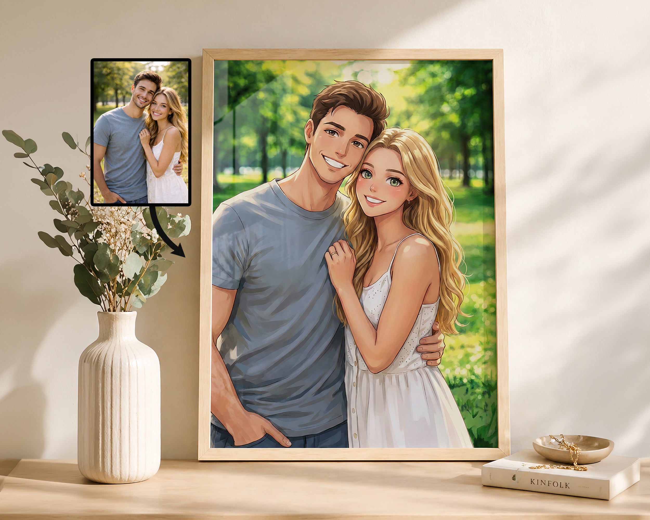 A framed custom portrait print of a couple, shown leaning on a shelf next to a vase with dried flowers. The main print is a stylized illustration of a smiling couple in a park, while a smaller photo of the original couple appears in the upper left corner of the print.
