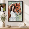 A framed custom portrait print of a woman in a white dress with a brown horse, displayed on a wall above a wooden console table with decorative vases and books. A smaller inset photo of the original reference image appears in the upper left with an arrow pointing to the artwork.