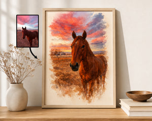 A framed watercolor-style horse portrait leaning against a wall on a wooden shelf, with a small inset preview of the original horse photo shown to the left. The artwork depicts a brown horse in a field under a vivid sunset sky in orange, pink, blue, and purple tones.