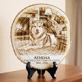 A personalized round wood slice plaque on a black display stand, featuring a engraved husky dog in a cozy living room with the text 'ATHENA FOREVER LOYAL. FOREVER LOVED 2014 - 2026'.
