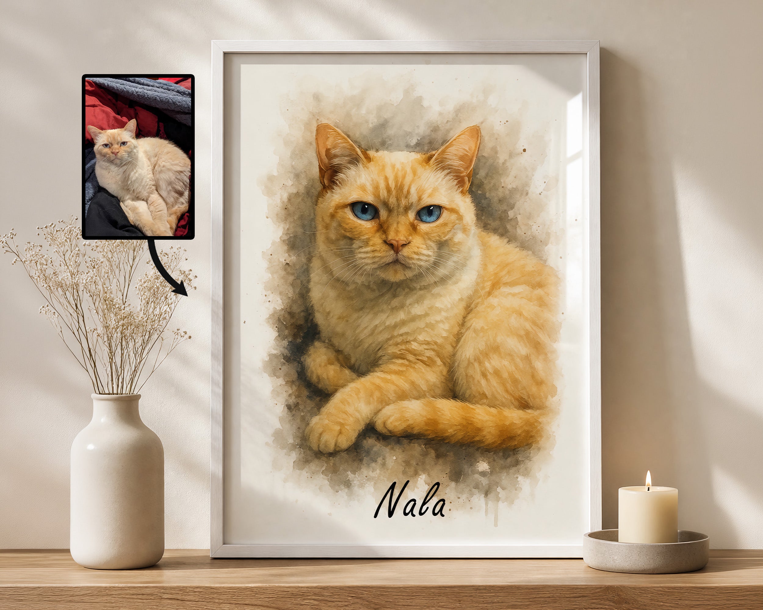 A framed custom watercolor cat portrait of an orange tabby cat with blue eyes, personalized with the name 'Nala' at the bottom. The white-framed print is displayed on a wooden shelf next to a white ceramic vase with dried stems and a lit candle, with a small inset photo of the original cat in the top-left corner.