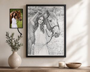 A framed black-and-white portrait drawing of a woman with a horse, displayed on a wall above a wooden shelf with a vase, candle, and bowl. A smaller inset photo of the original reference image appears to the left of the framed artwork.