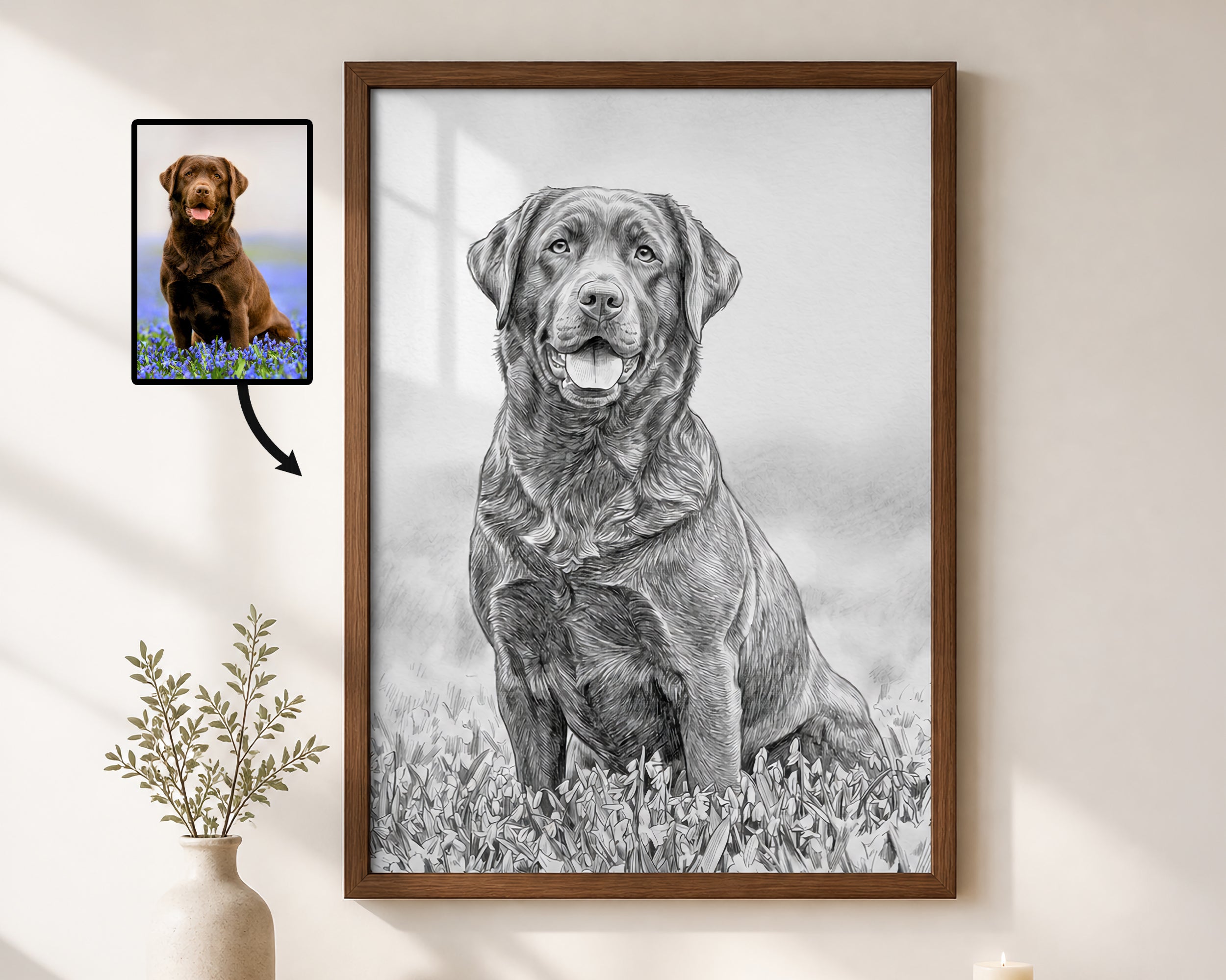 A framed black-and-white dog portrait hangs on a light beige wall, with a small inset photo of a brown dog and an arrow pointing to the artwork. The main product appears to be the framed custom-style dog art print, shown in a styled interior setting with a vase and candle.