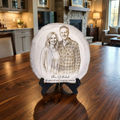 Decorative plate with a couple's portrait on a wooden table in a home setting