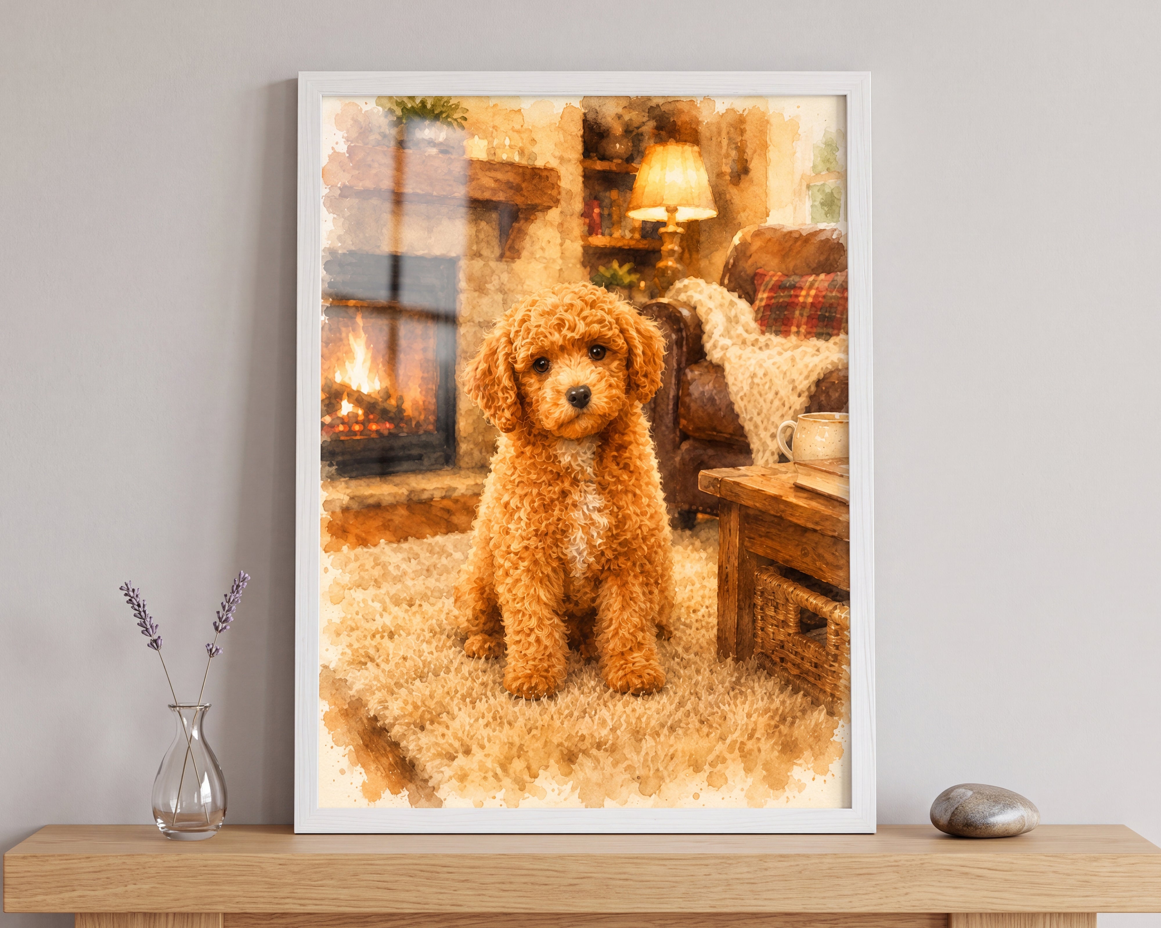 A framed custom pet portrait print of a fluffy golden-brown puppy sitting in a cozy living room with a fireplace, displayed on a wooden shelf next to a glass vase and a stone.