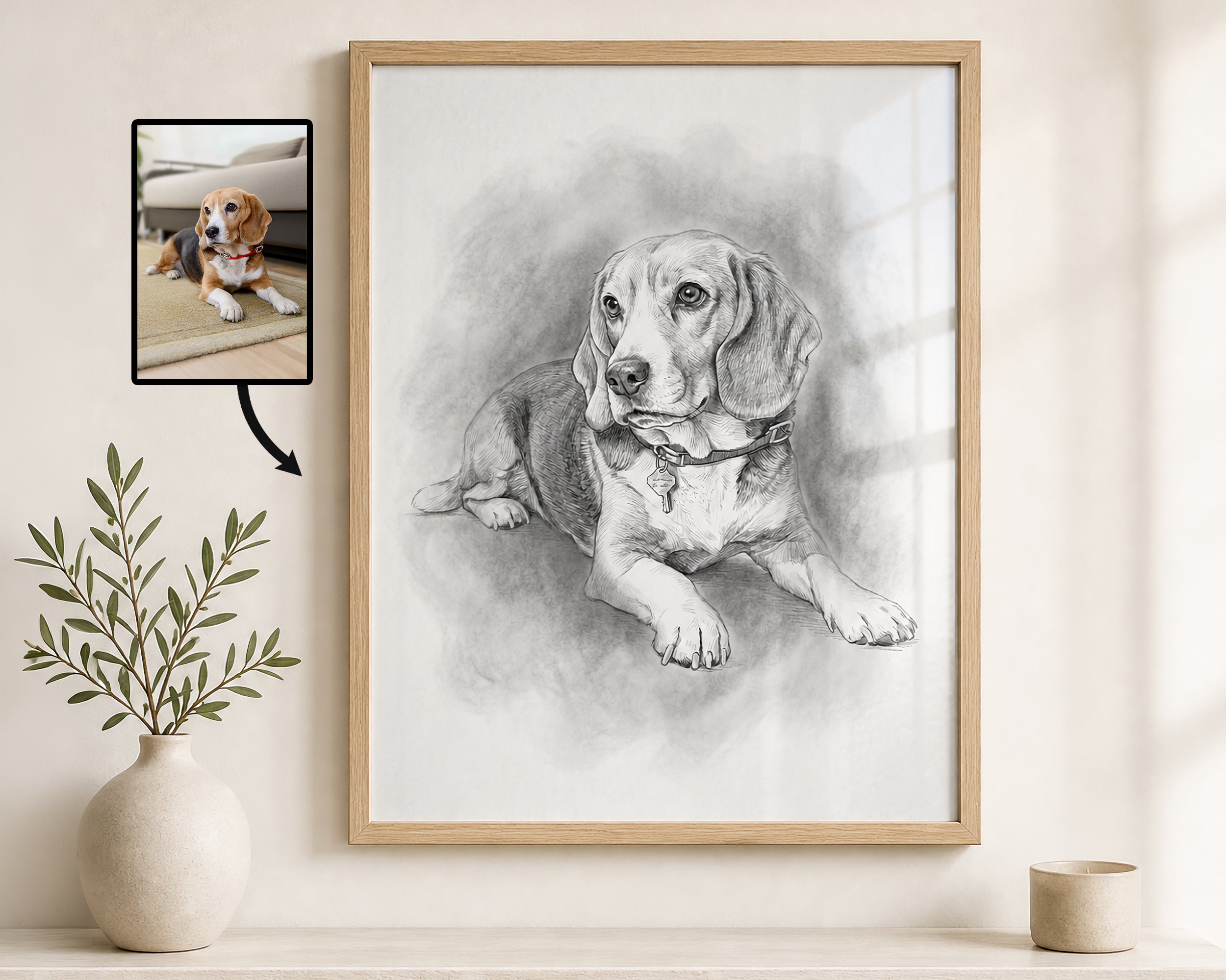 A framed custom pet portrait showing a detailed pencil sketch of a beagle lying down, displayed on a light beige wall above a shelf with a small plant in a vase. An inset image in the upper left shows the original photo of the beagle used for the portrait.