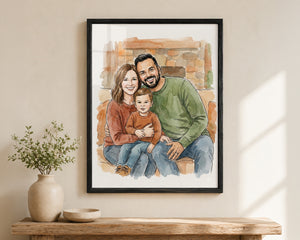 A framed custom watercolor portrait of a family of three, hanging on a beige wall above a wooden console table with a vase of greenery.