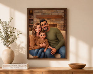 A framed custom family portrait print hanging on a beige wall above a wooden console table. The print shows a smiling man, a woman, and a young child sitting together in front of a stone fireplace.